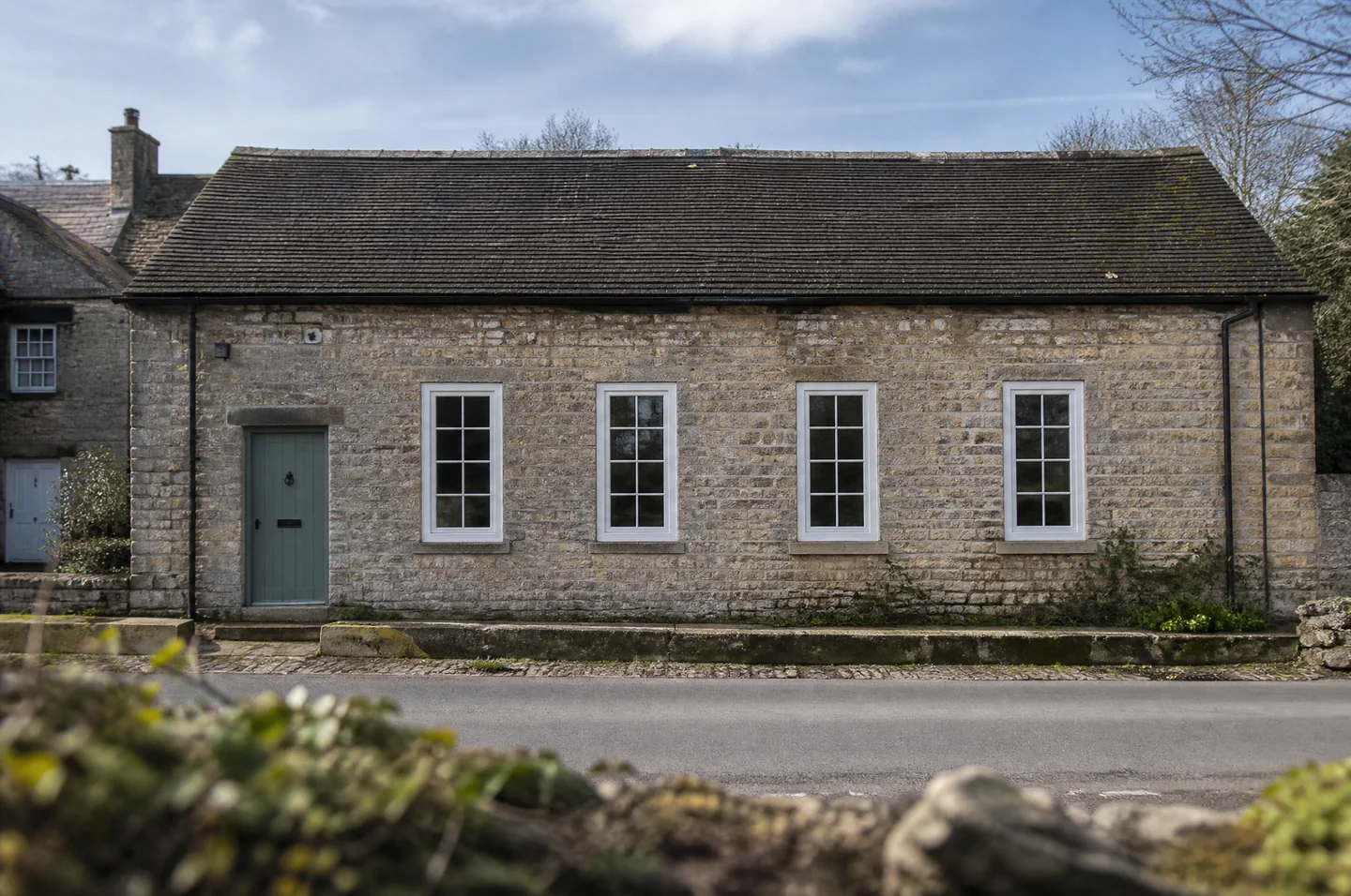 Light stone heritage cottage with white flush sash windows