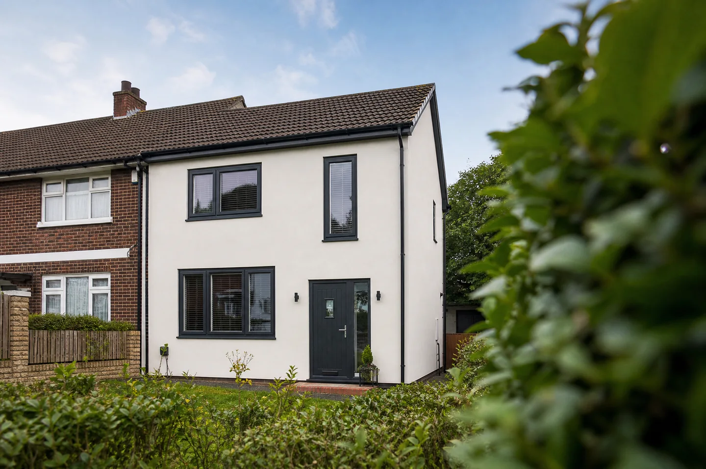 Rendered UK semi-detached home with anthracite grey windows and front door